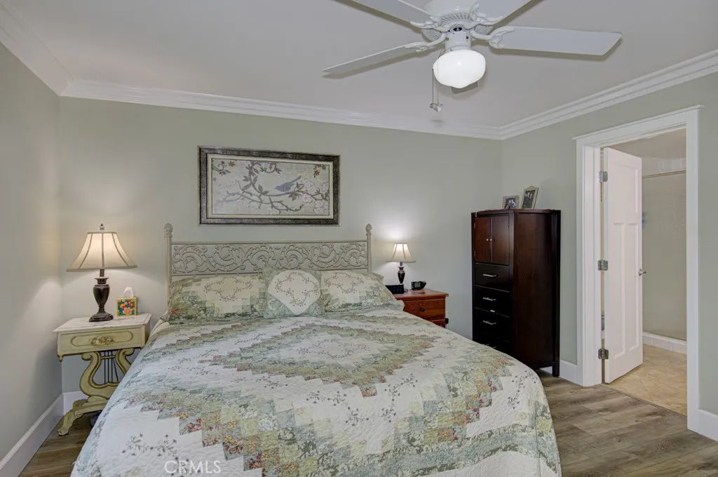 Another view of the primary bedroom suite. Entry to the bathroom at right.