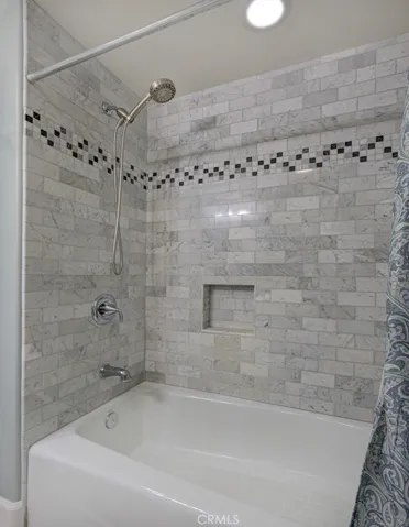 Shower-tub combo in guest bathroom.