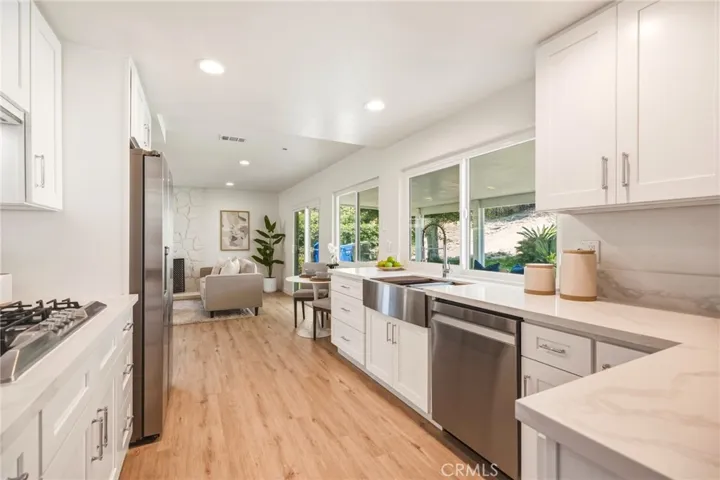 Chef’s kitchen with quartz countertops and backsplash