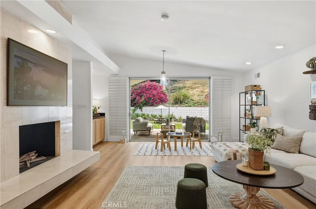Family room with marble faced fireplace