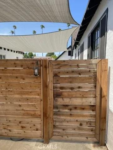 Enter through the front wooden gate