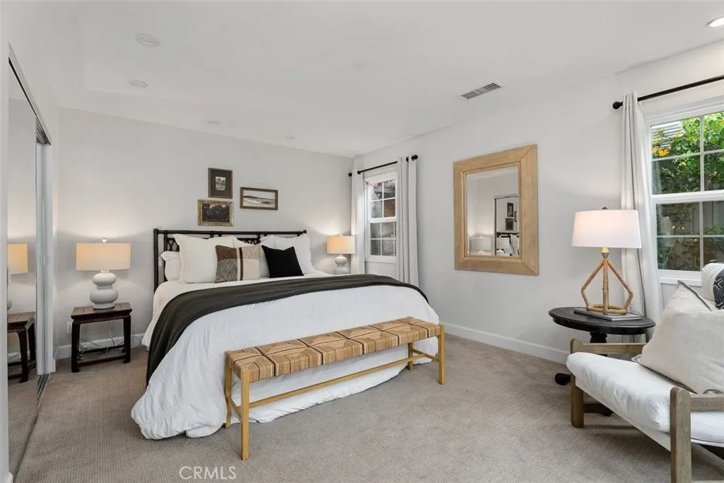 Spacious primary bedroom with views out to the courtyard. Spacious primary bedroom with views out to the courtyard.