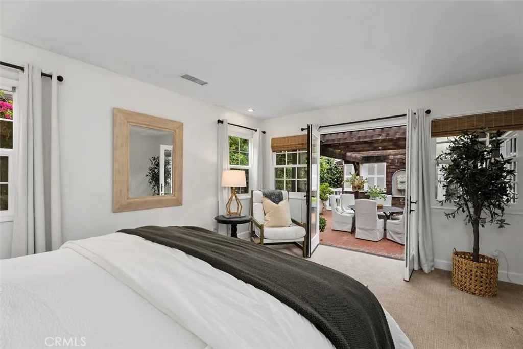 Primary bedroom opens with French doors leading out to the courtyard. Primary bedroom opens with French doors leading out to the courtyard.