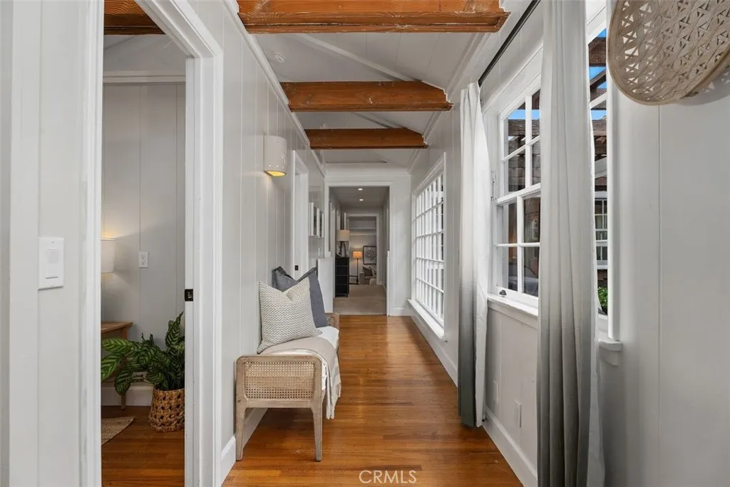 Hallway with plenty of light heading to the back of the home. Look at the real hardwood floors! Hallway with plenty of light heading to the back of the home. Look at the real hardwood floors!