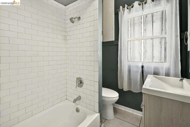 Bathtub with white subway tile surround and brushed nickel fixtures