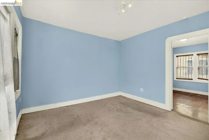 Room featuring light blue walls, white trim, and track lighting