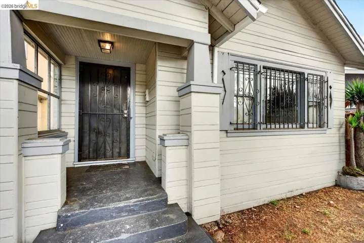 Front exterior featuring horizontal siding and a covered entry porch