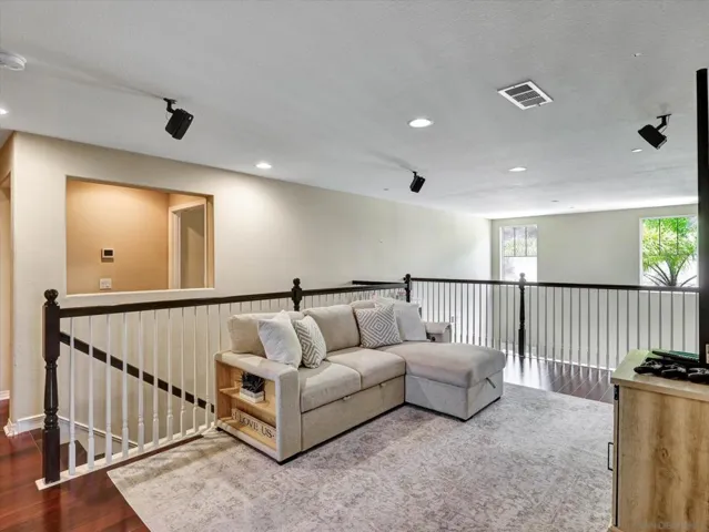 Beautiful loft overlooks the living room situated in between the primary bedroom and 3 guest bedrooms.