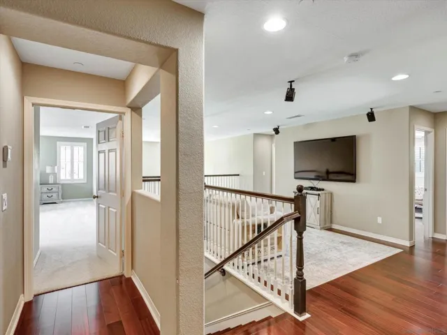 Beautiful loft overlooks the living room situated in between the primary bedroom and 3 guest bedrooms.
