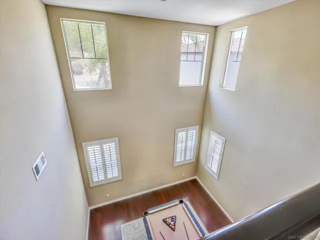 Beautiful loft overlooks the living room situated in between the primary bedroom and 3 guest bedrooms.