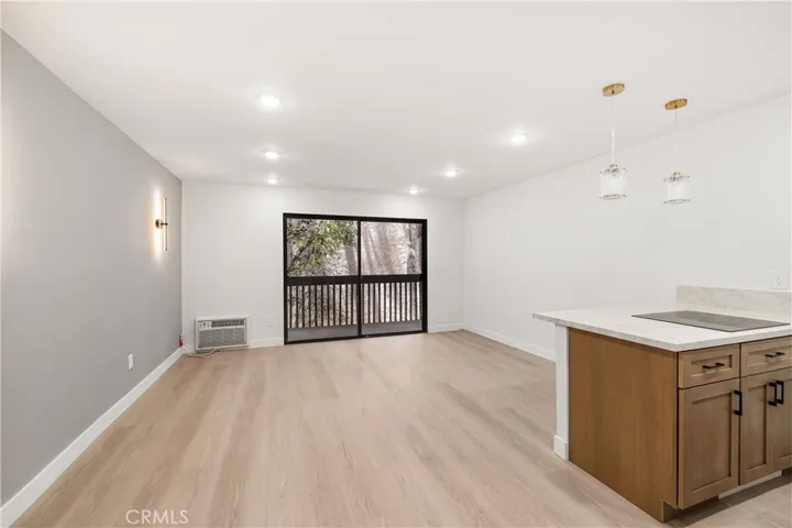 Bright open-concept living area with luxury wide plank vinyl flooring and abundant natural light.