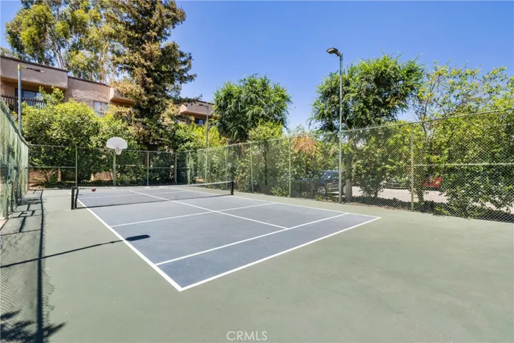 Private community tennis court for recreation and exercise.
