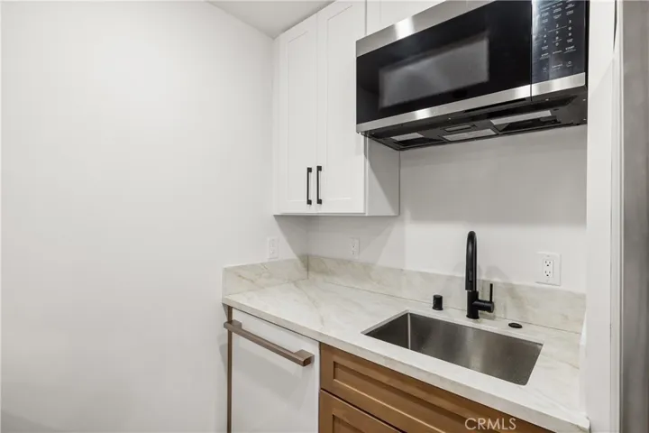 Modern kitchen with sleek cabinetry, stainless steel appliances, and ample storage.
