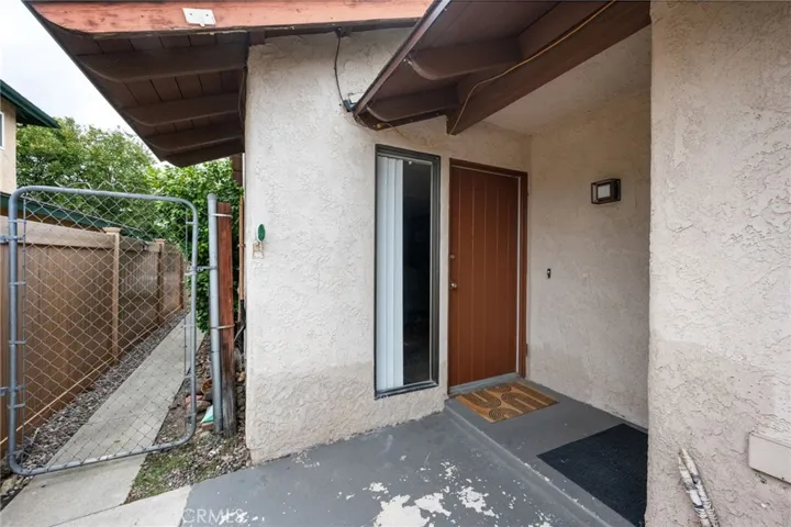 Small covered porch also leads to attached garage.
