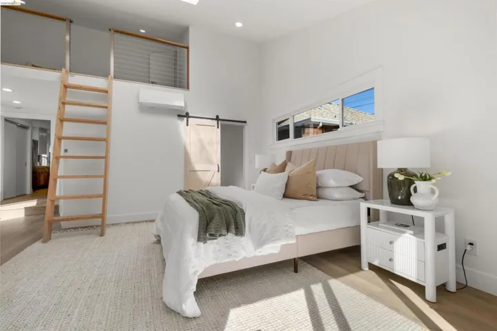 Bright room featuring high ceilings and wood-finish flooring