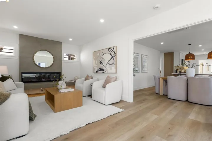 Living space featuring a linear electric fireplace with a concrete-finish surround and a built-in wood-finish media console