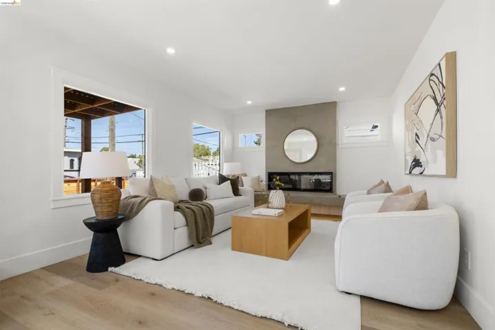 Bright living area featuring a modern fireplace with a concrete surround