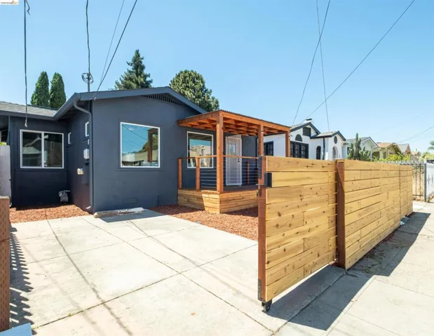 Modern exterior with dark gray stucco siding and white-framed windows