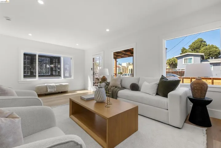 Bright living area featuring light wood-finish flooring and recessed lighting
