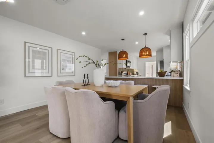 Dining area featuring wood-finish flooring, recessed lighting, and ample natural light from multiple windows