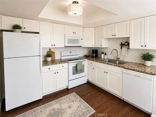 Kitchen with granite counters & white cabinets