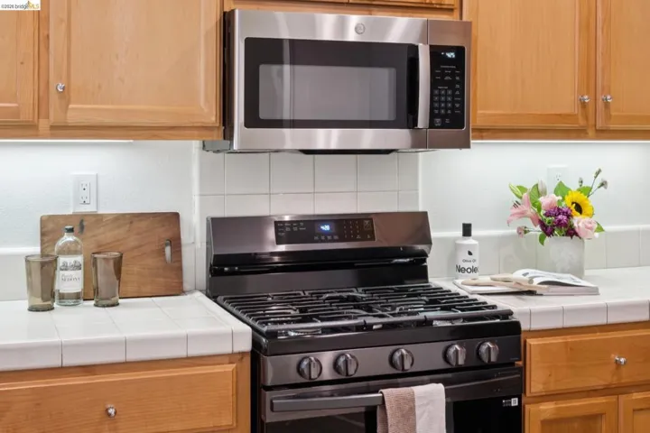 Modern stainless steel over-the-range microwave and gas range