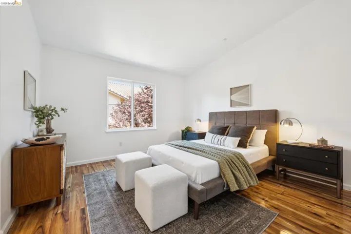Bright room with vaulted ceiling and wood-finish flooring