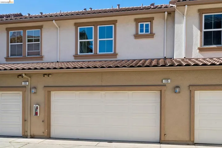 Stucco exterior with a tiled roofline
