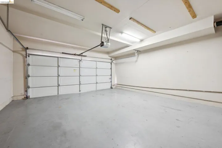 Garage with a light gray concrete floor and white painted walls