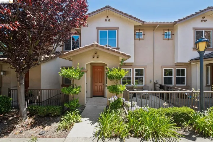 Stucco exterior with a terracotta tile roof accent