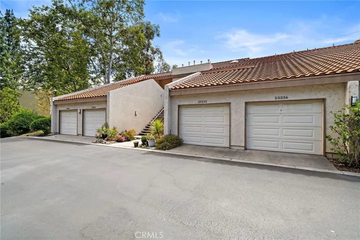 A detached one-car garage and a designated carport round out this alluring home.