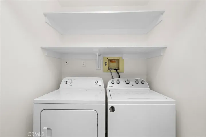 Dedicated side-by-side inside laundry with ample built-in overhead storage.
