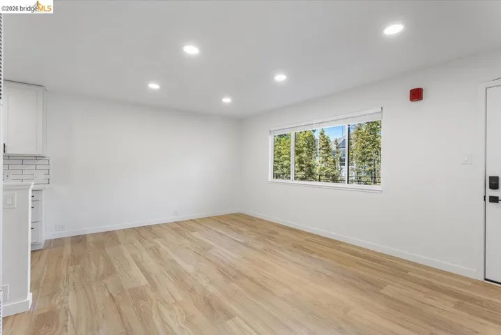 Unfurnished living room featuring light wood-style floors and recessed lighting