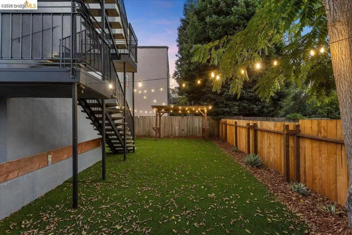 Fenced backyard featuring stairway