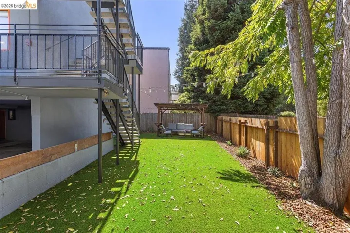 Fenced backyard with an outdoor living space and stairway