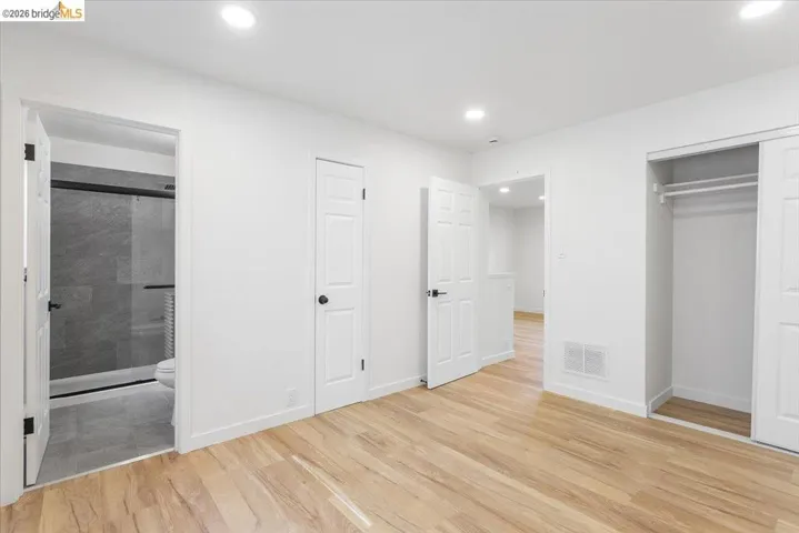 Unfurnished bedroom featuring recessed lighting, light wood-style flooring, a closet, and connected bathroom