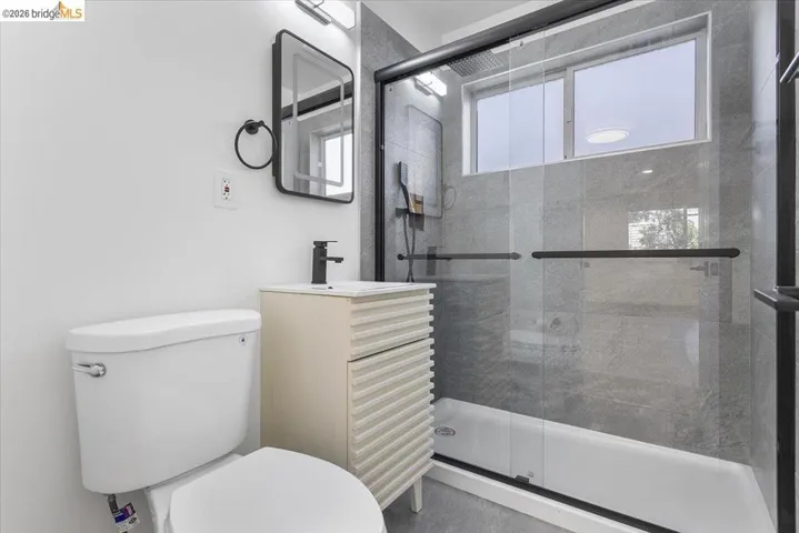 Full bath with a shower stall and vanity