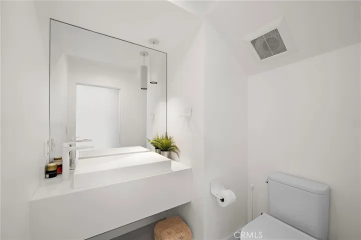 Modern half bath on main entertaining level.