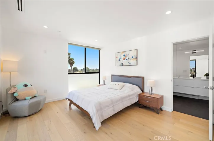 Third private en-suite bedroom that transitions seamlessly outdoors to an impressive rooftop entertainment terrace.