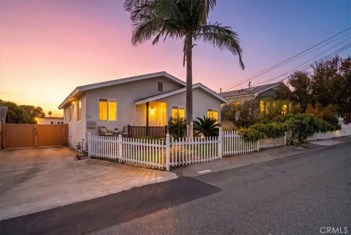 Front view of the property showcasing the charming exterior, inviting entry, and well-maintained curb appeal at dusk.
