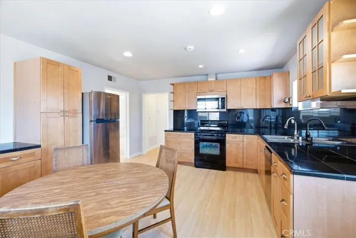 Kitchen perspective featuring ample cabinetry, modern finishes, and an open layout connecting to the dining area.