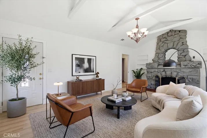 Living room view showcasing the cozy fireplace, open seating area, and bright interior with thoughtful details.