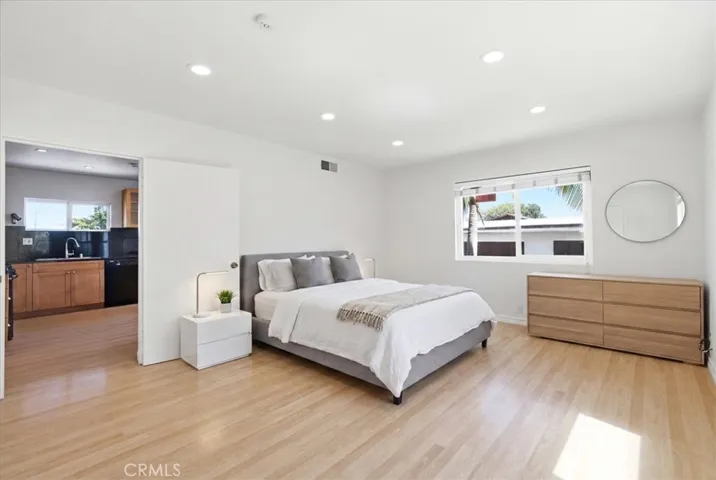 Additional bedroom perspective highlighting the open layout, wood flooring, and peaceful atmosphere.