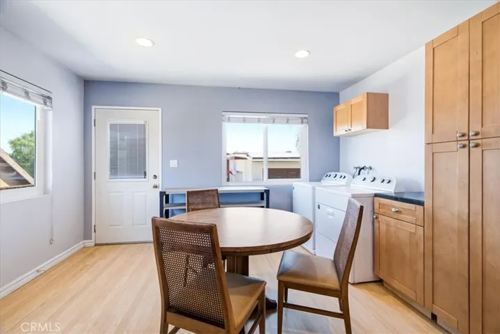 Kitchen and dining perspective capturing the home's airy layout, wood finishes, and functional living design.