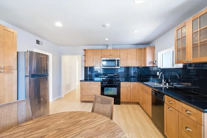 View connecting the kitchen and living areas, highlighting the open floor plan and inviting flow throughout the home.