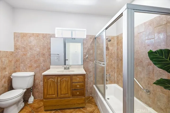 Bathroom view showcasing the functional layout, vanity area, and updated tile details.