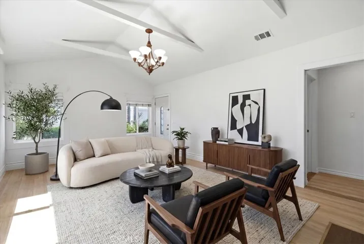 Additional living area view showcasing the spacious layout, fireplace feature, and natural light throughout the room.