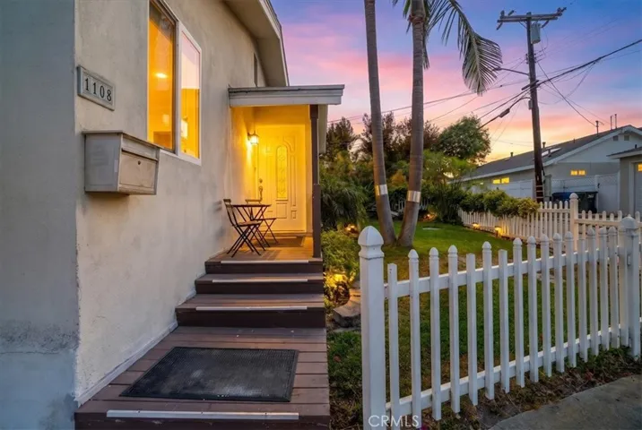 Closer view of the front entry showcasing the pathway, steps, and thoughtful details leading into the home.