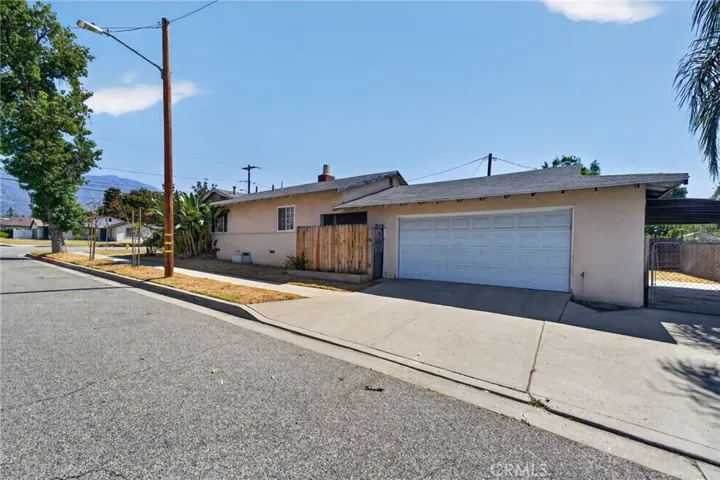 Corner Lot side of home with 2 car garage and side carport.