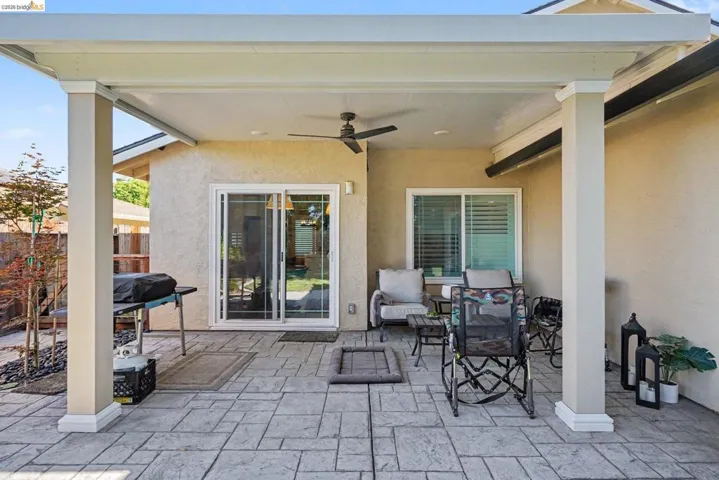 Covered patio featuring stamped concrete flooring